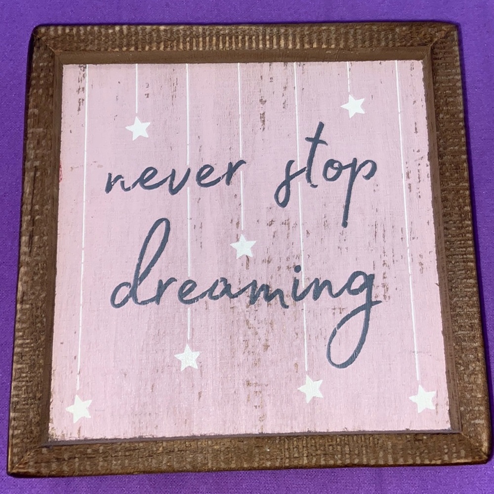 “never stop dreaming” wood sign